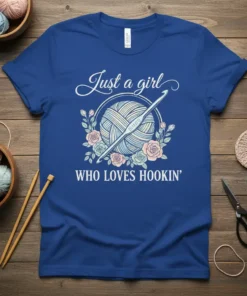 Just a girl WHO LOVES HOOKIN' text with yarn ball and crochet hook graphic on a royal blue t-shirt