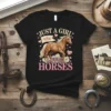 Just A Girl Who Loves Horses text with a running horse graphic and pink hearts on a black t-shirt
