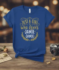 Just A Girl Who Loves Jamie Jamie text design with gold glitter font and laurel wreath on a blue t-shirt