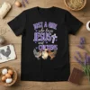 Just A Girl Who Loves Jesus and Chickens text design with three chickens and a cross graphic on a black