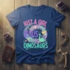 Just A Girl Who Loves Jesus and Dinosaurs text with cartoon Jesus cross and dinosaur graphic on a blue t-shirt