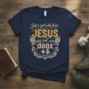 Just a girl who loves JESUS and dogs text design with floral accents and paw prints on a navy t-shirt