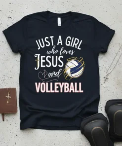 Black t-shirt with white and pink text "JUST A GIRL who loves JESUS and VOLLEYBALL" and a graphic of a