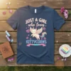 JUST A GIRL who loves KITTYCORNS text with a cute cat unicorn graphic on a navy blue t-shirt