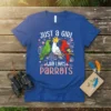 Just a Girl Who Loves Parrots t-shirt design featuring three colorful parrots sitting on a branch with floral accents