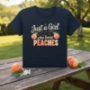 T-shirt with "Just a Girl who loves PEACHES" text and peach graphics, navy blue tee