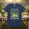 T-shirt design with text "JUST A GIRL WHO LOVES PICKLES" above a graphic of cucumbers and green hearts