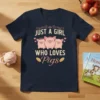 Just a Girl Who Loves Pigs text design with three cute cartoon pigs wearing crowns and flowers, on a navy