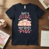 Just A Girl Who LOVES PIGS text with three cute cartoon pigs illustration on a navy blue t-shirt