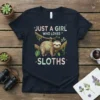 Just A Girl Who Loves Sloths text with a cute sloth hanging on a branch, on a navy t-shirt