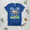 Blue t-shirt with "JUST A GIRL WHO LOVES SLOTHS" text and a cute sloth illustration surrounded by flowers