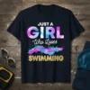 Just A Girl Who Loves Swimming text with a watercolor swimmer graphic and gold glitter effect on a navy t-shirt
