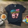 T-shirt with neon text "JUST A MOM WHO IS TIRED OF HEARING" above a large "67" graphic for a 67th
