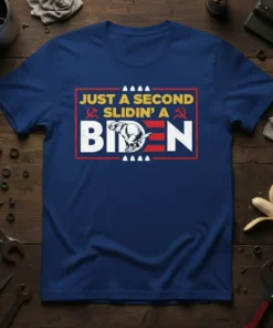Just A Second Slidin' A Biden T-Shirt featuring bold text and a humorous graphic illustration. The design is printed on