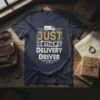 Just The Delivery Driver text design with a graphic of a delivery van and decorative elements on a navy t-shirt
