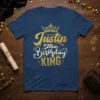 Justin The Birthday KING text design with a crown graphic on a navy blue t-shirt