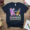 Navy t-shirt with "K IS FOR KINDNESS" text and a cute pencil graphic wearing a party hat
