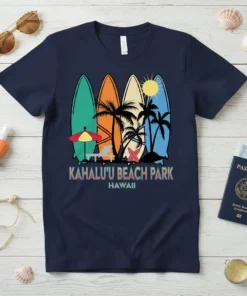 Navy t-shirt featuring "Kahalu'u Beach Park Hawaii" text with colorful surfboards, palm trees, and sun graphic