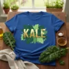 Royal blue t-shirt with the word KALE in bold gold lettering surrounded by green kale leaves illustration
