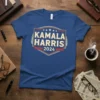 Blue t-shirt with "Kamala Harris 2024" text in a vintage shield design with stars and stripes, political campaign apparel