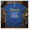 Kamala /ka:malâ/ If that's too hard to pronounce try... Madam President quote on a blue t-shirt, gold and gradient text