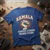 Kamala Removes Stubborn Orange Stains text design with a raised fist holding a scrub brush graphic on a blue t-shirt