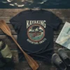 Kayaking Adventure Awaits graphic tee with a kayaker on waves, mountains, and moon