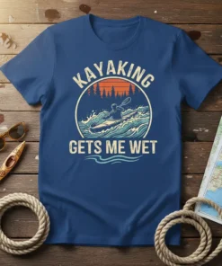Kayaking Gets Me Wet funny t-shirt design with a kayaker paddling through waves at sunset