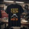 Keep Calm & Let Joe Fix It quote with crossed hammers graphic on a black t-shirt