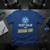 Blue t-shirt with white text "KEEP CALM AND BEAM ON" and a radiation symbol graphic