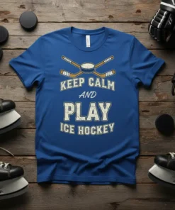 Keep Calm And Play Ice Hockey text with crossed hockey sticks and puck graphic on a royal blue t-shirt