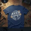 Keep Hammering t-shirt design featuring metallic text, gears, and a hammer graphic with orange sparks