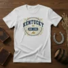 Kentucky Est 1792 t-shirt with blue text, gold ornate border, and horse graphic