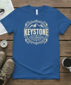 Keystone Colorado t-shirt design featuring mountains, trees, and decorative border