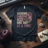 Kicking Cancers Ass One Day At A Time t-shirt with purple ribbon and feathers design