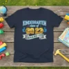 Kindergarten Class of 2023 Nailed It t-shirt design with blue neon text, gold numbers, and thumbs up graphics