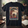 Kiss More Boys t-shirt design featuring two people kissing, with celestial and floral motifs, in a tarot card style
