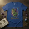 Kiss my butt frog with fairy wings and horns on a blue t-shirt, featuring starry background and moon