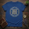Blue t-shirt with gold text "Know Jesus Know Jesus Know Peace Know Peace" in a circular design with laurel wreath