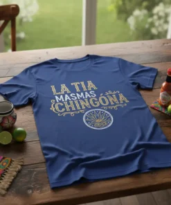La Tia Masmas Chingona phrase in gold glitter font on a navy blue t-shirt with a lotus design below
