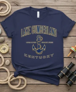Navy blue t-shirt with gold text "Lake Cumberland Unsalted Shark Free Kentucky" and an anchor graphic