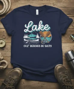 Lake Cuz' Beaches Be Salty t-shirt featuring a canoe, oars, mountains, and sunset graphic
