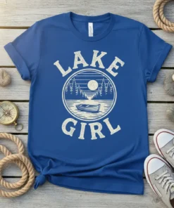 Blue t-shirt with "Lake Girl" text and a vintage circular graphic of a lake, trees, moon, and boat