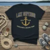 Navy t-shirt featuring "Lake Superior Est. 1763 Unsalted & Shark Free" text with a gold anchor graphic