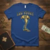 Blue t-shirt with "LEG STORY $10" text above a golden prosthetic leg graphic
