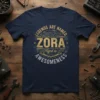 T-shirt featuring "LEGENDS ARE NAMED ZORA Aged to AWESOMENESS" in vintage gold and silver text with gear graphics