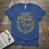 Blue t-shirt with gold lettering: "LET EVERYTHING THAT HAS BREATH Praise the Lord Psalm 150:6", surrounded by a decorative vine