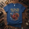 Thanksgiving turkey wearing a hat holding a hairdryer with "Let Me Fix Your Hair" text, graphic tee design