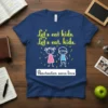 Navy blue t-shirt with yellow text "Let's eat kids. Let's eat, kids." above cartoon children and white text "Punctuation saves