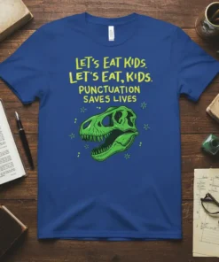T-shirt with yellow text "Let's Eat Kids. Let's Eat, Kids. Punctuation Saves Lives." above a green dinosaur skull graphic
